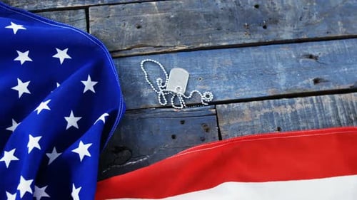 American Flag and Dog Tags on Wooden Surface