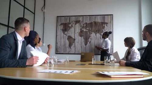 African American Female Business Coach Gives Corporate Presentation for Businesspeople in Office