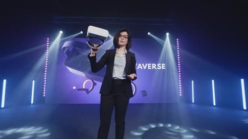 Woman Presenting Virtual Reality Technology on Stage