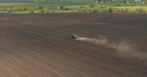 Farmer is Loosening Soil By Tractor Preparing Farmland for Sowing View From Drone Prores