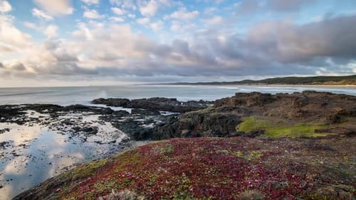 Clouds Moving Fast over Ocean Rocky Coast at Sunset Time lapse