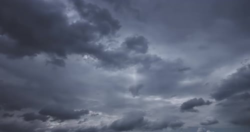 4K time lapse of dark sky, storm clouds with sun rays.