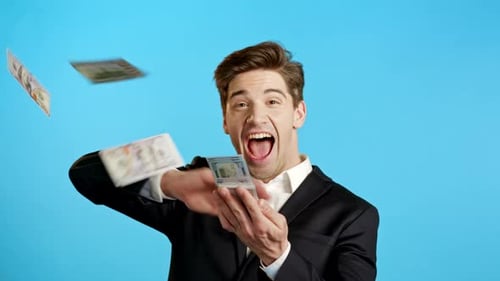 Excited Man Throwing Money on Blue Background