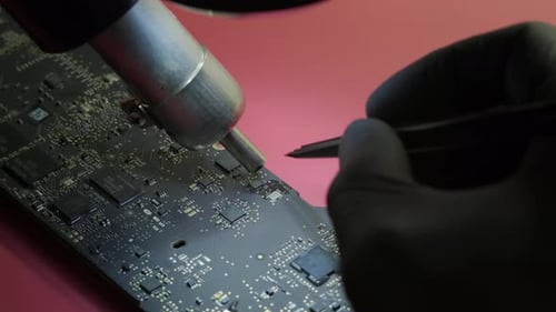Close Up Macro View of Electronic Renovation in Repair Shop Treplaces an Electrical Part in the