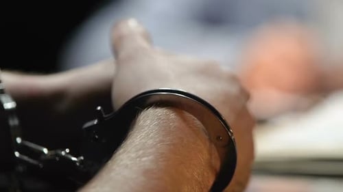 Detained Thief Answering Lawyer Questions in Police Station, Handcuffs Close Up