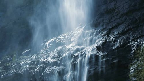 Majestic Waterfall Flowing Down Rocky Cliffside