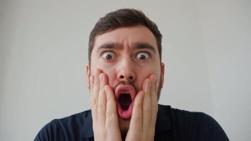 Man Reacts with Open Mouth in Shock