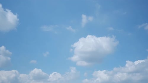 Clouds Drifting across Blue Sky in Time Lapse