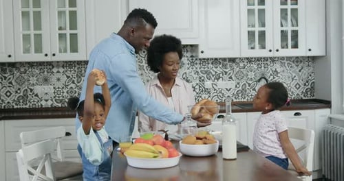 Happy Family Enjoys Breakfast in Bright Kitchen