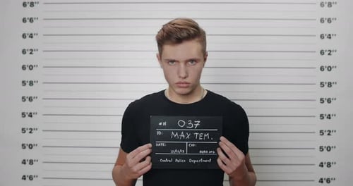 Young Adult Posing For Mugshot