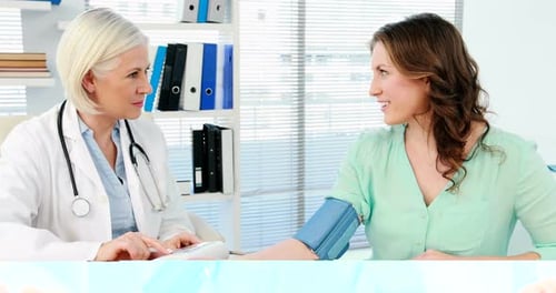 Doctor Takes Blood Pressure of an Adult Woman