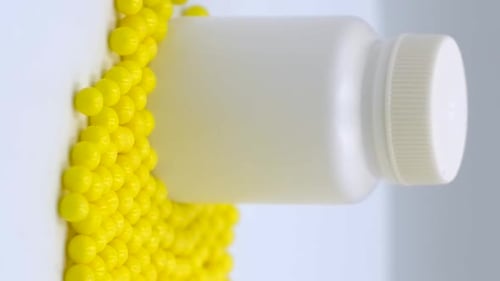 Vertical orientation video: Vitamin C to improve immunity. Ascorbic acid in a dragee
