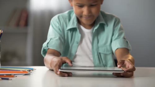Little Boy Actively Playing on Tablet After School, Online Gaming Addiction