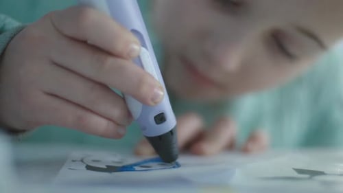 Child Drawing with a 3D Pen Indoors