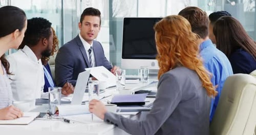Diverse Colleagues Collaborating at Table in Bright Office