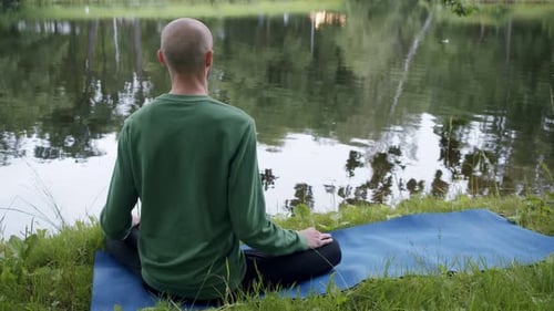 Meditative Man Practicing Yoga by a Serene Lake