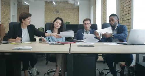 Wide Shot of Multiracial Business Partners Signing Documents in Office. Serious Confident Caucasian