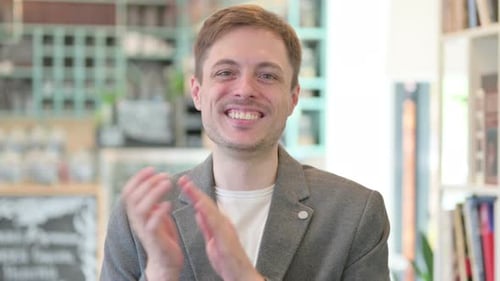 Man Clapping Hands in Cheerful Applause