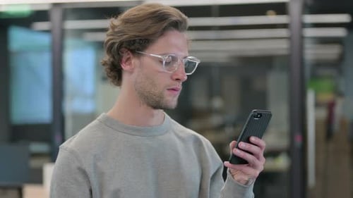 Portrait of Young Businessman Using Smartphone