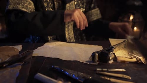 Man Writes with Quill Pen in Candle Light