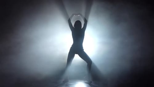 Silhouette Langbeinige Mädchen tanzt im Smoky Studio. Zeitlupe