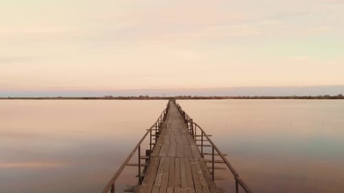 Empty wooden bridge over estuary lake sea