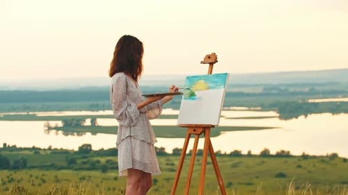 Young Woman Painting Landscape in Rural Field