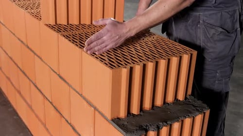 Detail of worker and layers of bricks