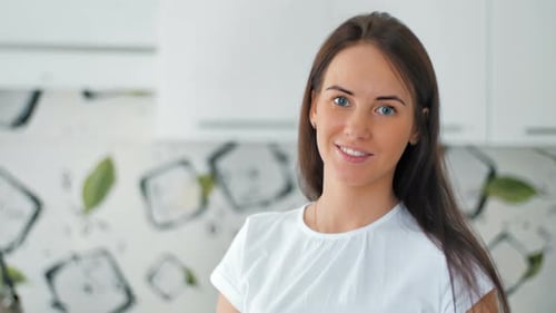 Beautiful Smiling Woman Portrait in Modern Kitchen