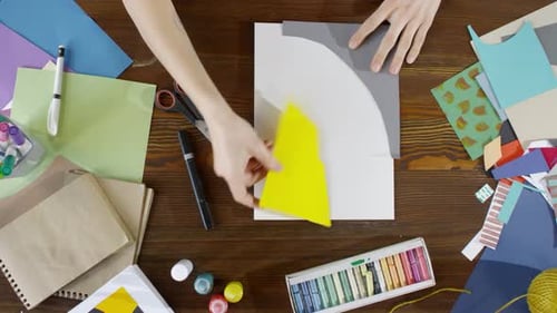 Paper Art with Geometric Shapes on a Wooden Table