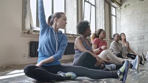 Women Stretching with Female Instructor