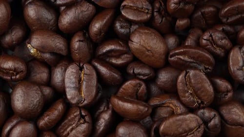 close up of roasted coffee beans rotating, seeds of coffee
