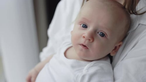 Adorable Baby Held Tenderly by Loving Parent