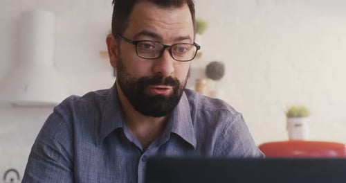 Man Attending Online Meeting At Home
