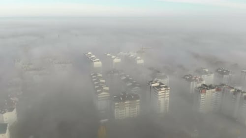 Aerial View at the Houses That Are Covered with Morning Fog. Flight Over the City of Lviv in Ukraine