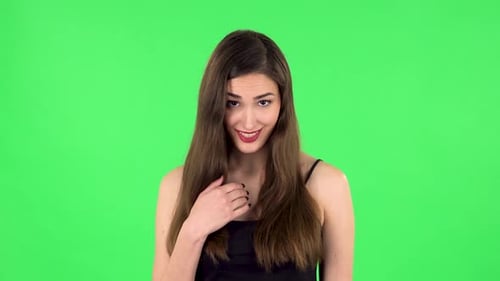 Indignant Woman Throwing Up Hands Expressing She Is Innocent, Twists His Finger at His Temple. Green