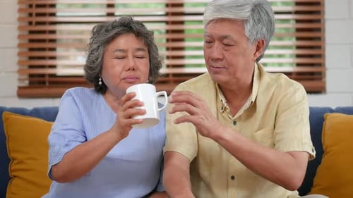 Loving Elderly Couple Taking Medication Together at Home