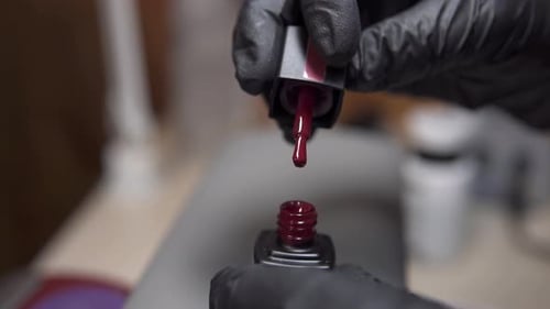 Opening Bottle of Dark Red Nail Polish Close-Up