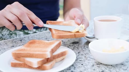 Buttering Toast with a Knife at Breakfast