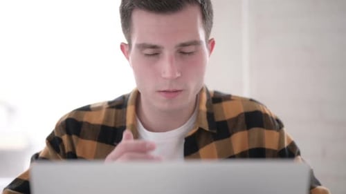 Close Up of Young Man with Headache Working on Laptop