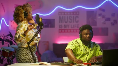 Female Singer Recording Song with DJ in Audio Studio