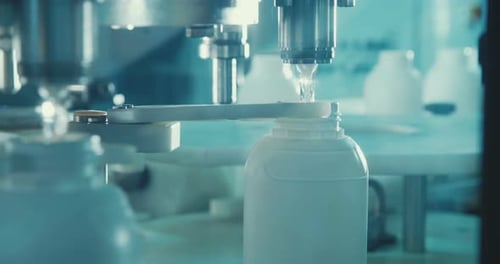 Filling of chemical bottles in a production line