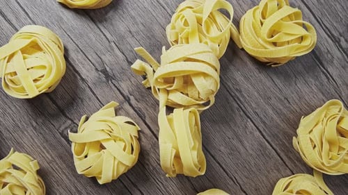 the Spaghetti Crumbles and Falls on the Wood Table. Slow Motion