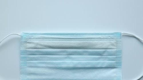 Vaccinate Concept with Face Mask and Letter Tiles