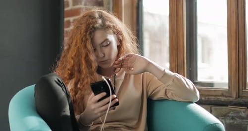 Young Woman Listening to Music on Smartphone