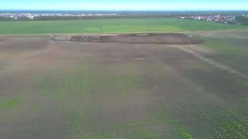 Aerial Motion Over Field To Little Tractor Cultivating Soil