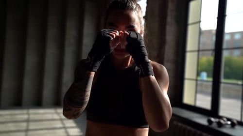 Strong Woman Boxing, Punching in Urban Gym