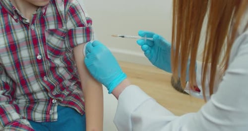 Child Receives Vaccine Injection at Doctor's Office