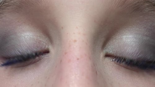 Close-Up of Eyes with White Eyeshadow and Blue Mascara