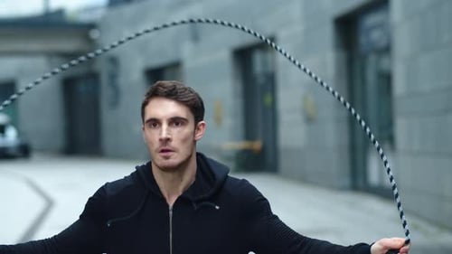 Young Man Jumping Rope in Urban Alley